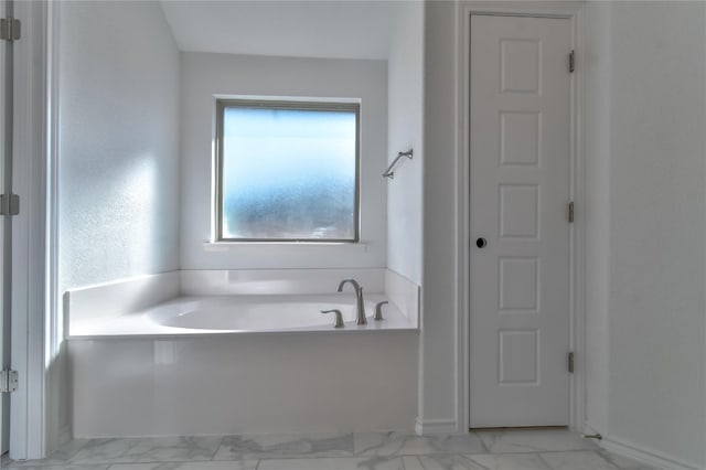 bathroom with tile floors and a washtub