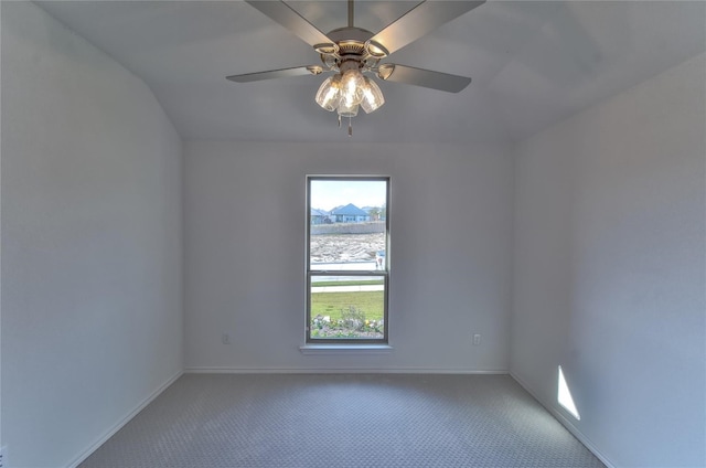 carpeted empty room featuring plenty of natural light, lofted ceiling, and ceiling fan