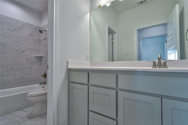 full bathroom featuring tile flooring, large vanity, toilet, and tiled shower / bath