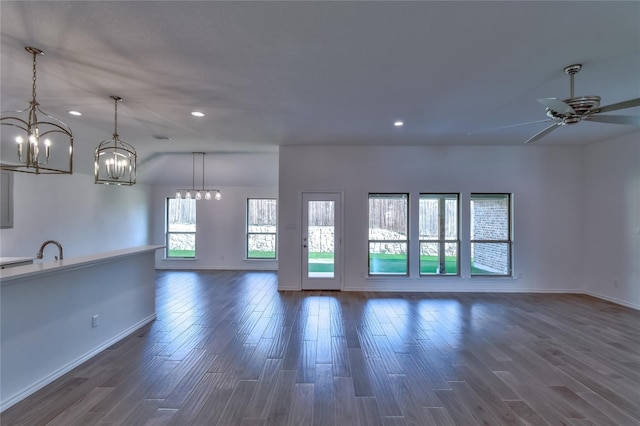 empty room featuring dark hardwood / wood-style floors and ceiling fan with notable chandelier