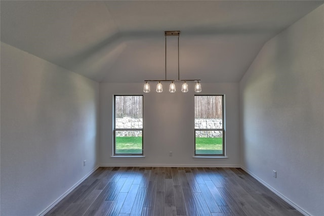 unfurnished room with vaulted ceiling, dark wood-type flooring, and a wealth of natural light