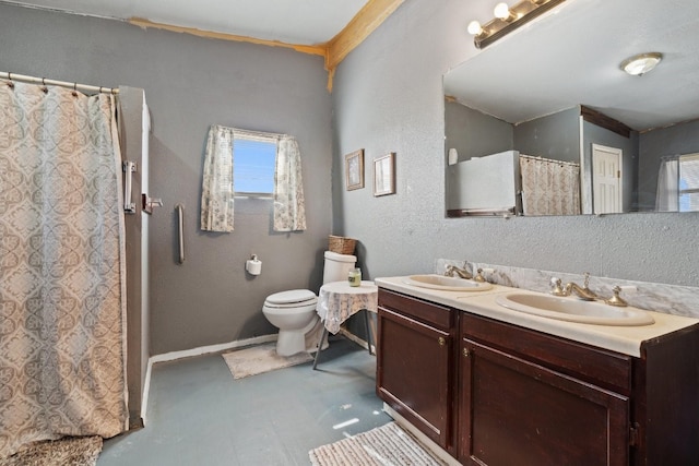 bathroom with dual bowl vanity and toilet