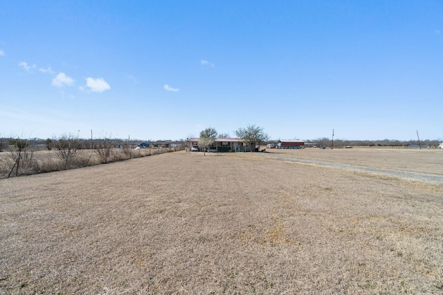 view of yard with a rural view