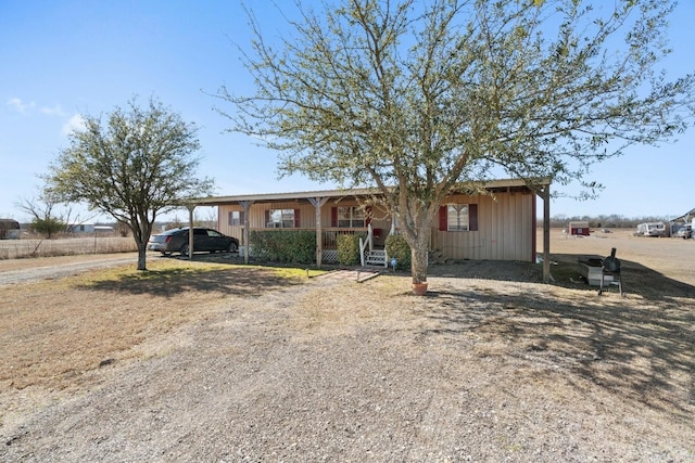 single story home featuring covered porch and a carport