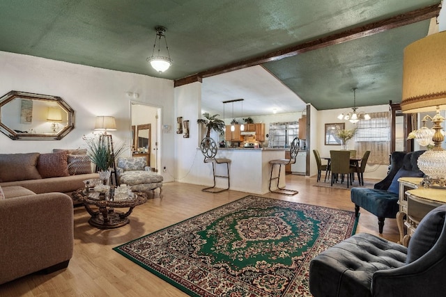 living room featuring light hardwood / wood-style flooring and an inviting chandelier