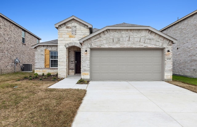 view of front of property with central AC and a garage