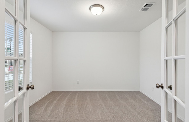 empty room featuring light carpet