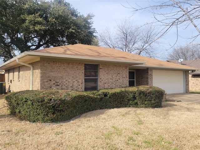 single story home featuring a front lawn, central AC, and a garage