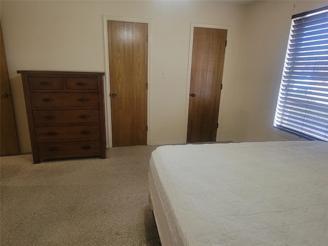 bedroom with light colored carpet