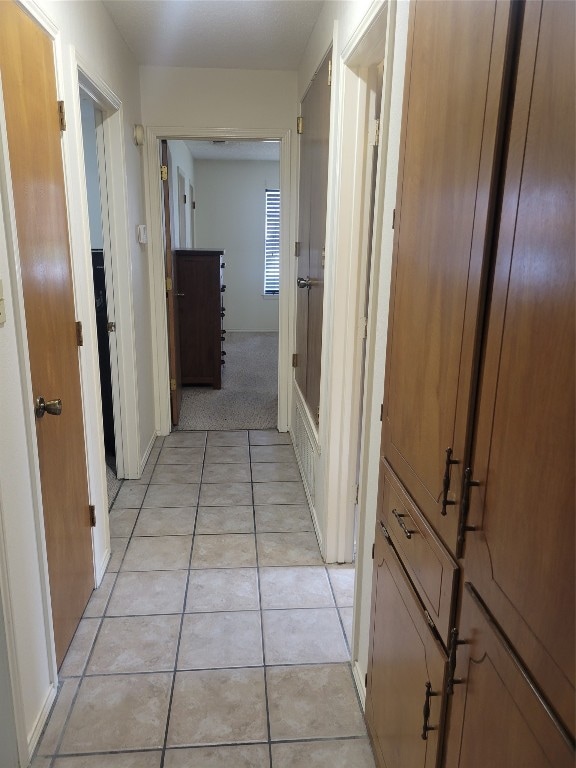 hallway featuring light tile floors