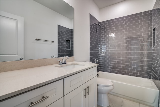 full bathroom with toilet, tiled shower / bath, vanity, and tile patterned floors