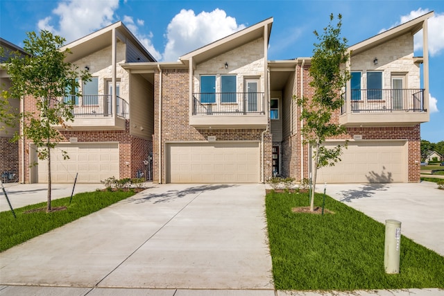 multi unit property featuring a balcony and a garage