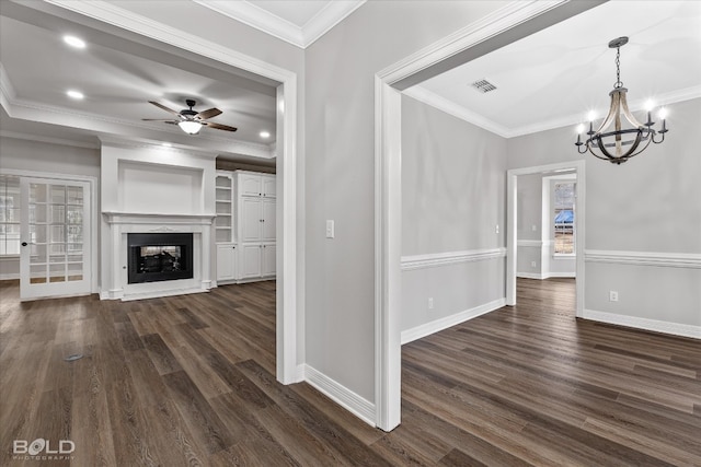 unfurnished living room featuring a high end fireplace, ornamental molding, dark wood-type flooring, and ceiling fan with notable chandelier