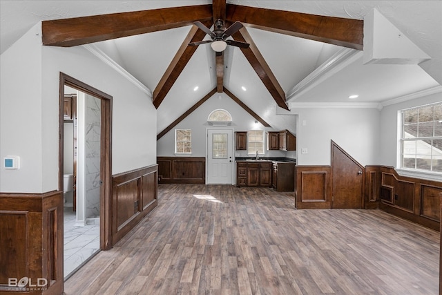 kitchen featuring ornamental molding, ceiling fan, hardwood / wood-style flooring, and beamed ceiling