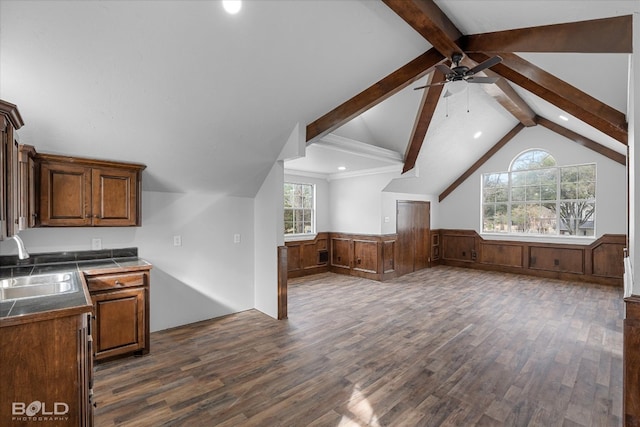 interior space with ceiling fan, sink, vaulted ceiling with beams, and dark wood-type flooring