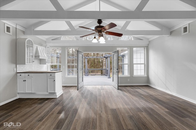 interior space featuring plenty of natural light, ceiling fan, dark hardwood / wood-style floors, and white cabinetry