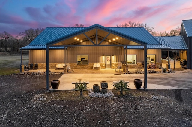 back house at dusk with a patio area