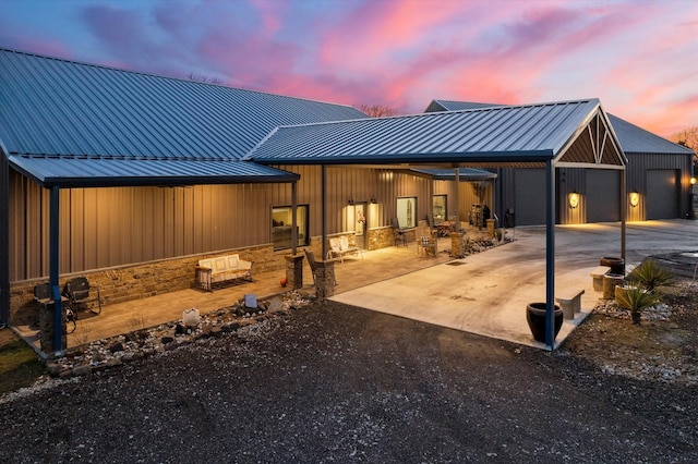 back house at dusk with a garage