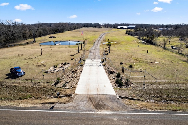 drone / aerial view featuring a rural view and a water view