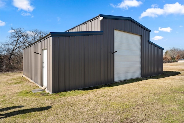 view of outbuilding with a garage and a yard