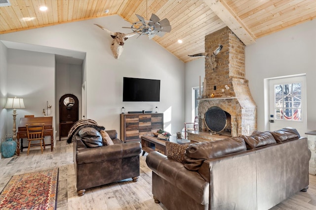 living room featuring wood ceiling, high vaulted ceiling, ceiling fan, a fireplace, and light hardwood / wood-style floors