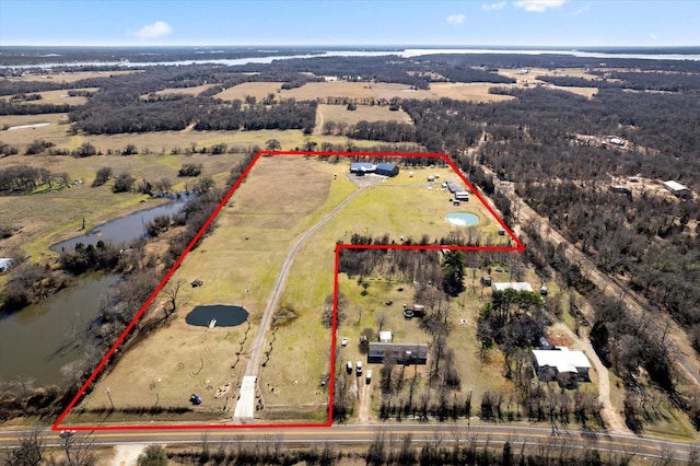 birds eye view of property featuring a water view and a rural view