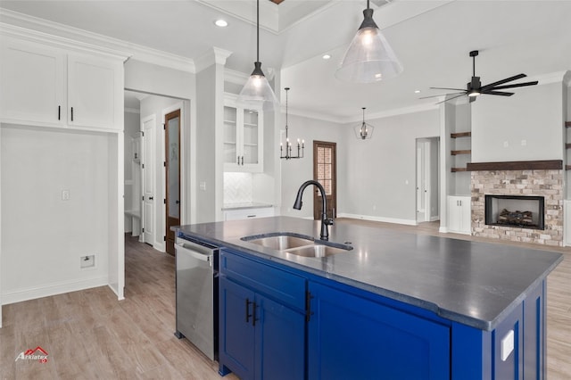 kitchen with blue cabinets, white cabinets, crown molding, and light hardwood / wood-style flooring