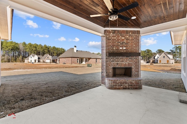 view of patio / terrace featuring ceiling fan and an outdoor brick fireplace