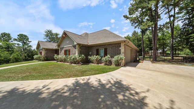 view of front of house with a garage and a front yard