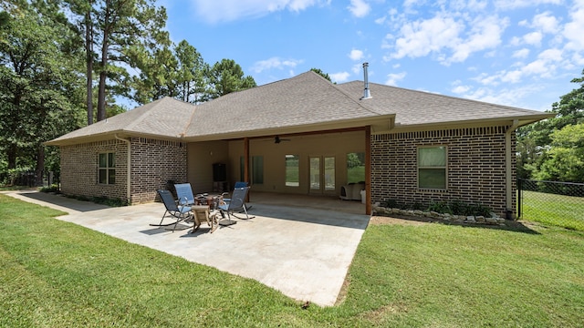 rear view of house with a patio, a lawn, and ceiling fan