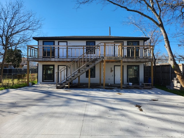 back of house featuring a balcony