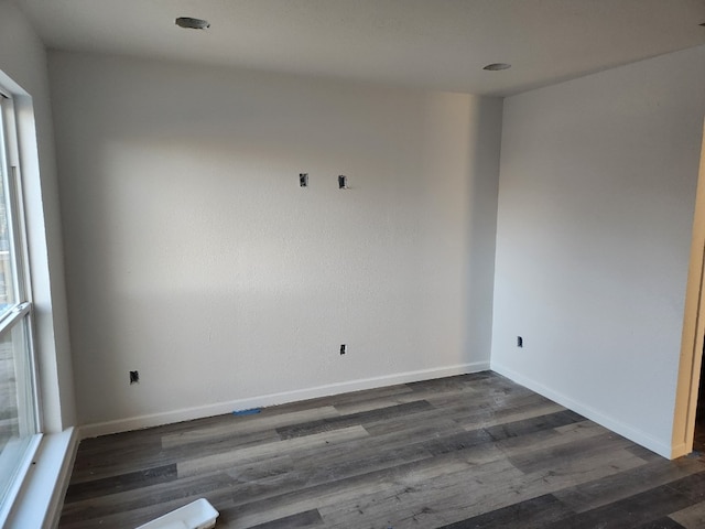 unfurnished room featuring dark wood-type flooring