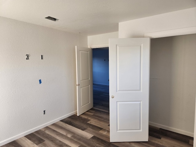 unfurnished room featuring dark hardwood / wood-style floors