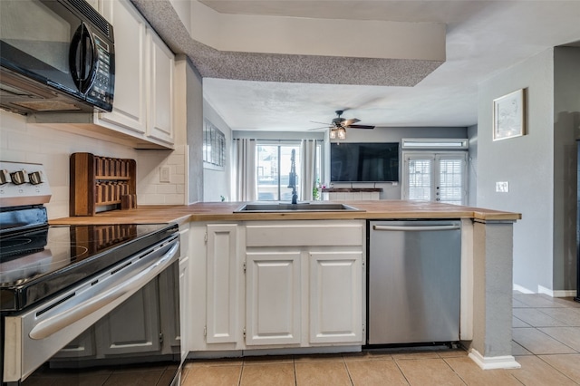 kitchen featuring stainless steel appliances, ceiling fan, white cabinetry, and light tile floors