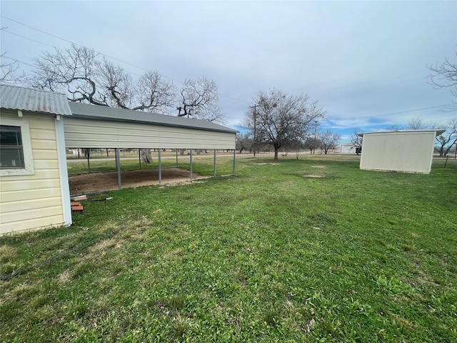 view of yard with a carport and a shed