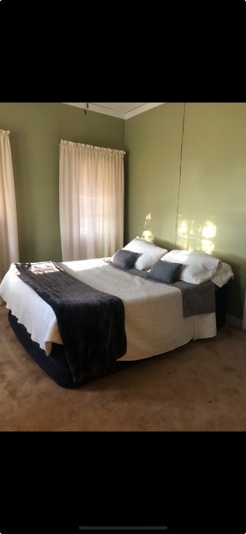 bedroom featuring carpet flooring and ornamental molding