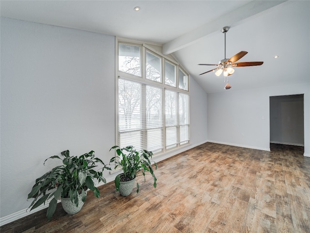 unfurnished room with light hardwood / wood-style floors, ceiling fan, and vaulted ceiling with beams