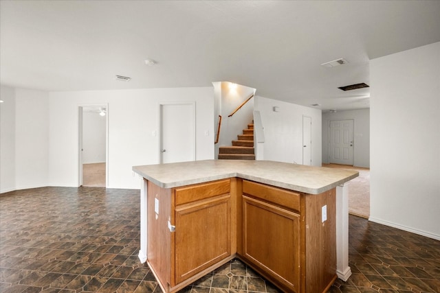 kitchen featuring dark tile flooring and a kitchen island