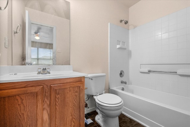 full bathroom with vanity, tiled shower / bath combo, ceiling fan, tile flooring, and toilet