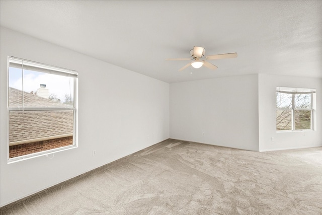 carpeted empty room with ceiling fan