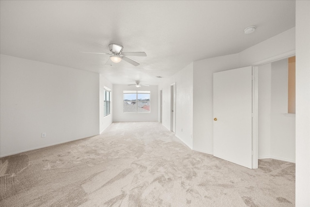 unfurnished room featuring light carpet and ceiling fan