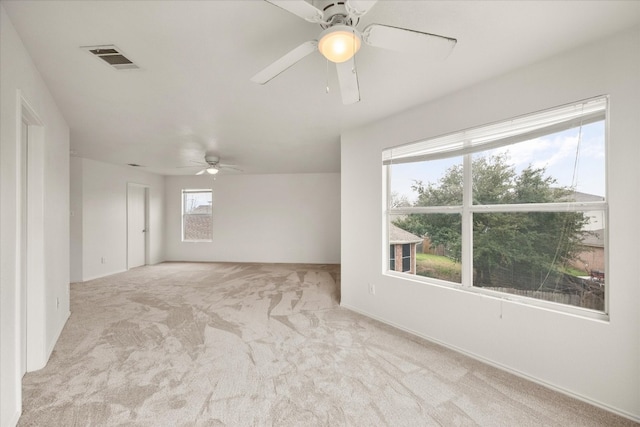 spare room with ceiling fan and a wealth of natural light