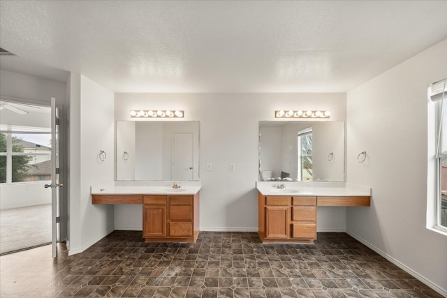 bathroom featuring double vanity, tile flooring, ceiling fan, and a textured ceiling