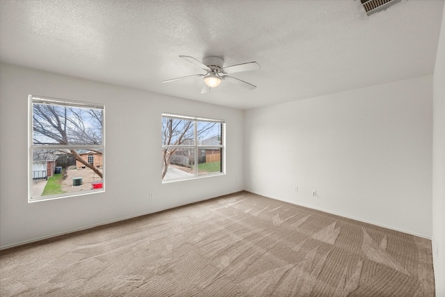 unfurnished room with light carpet, ceiling fan, and a wealth of natural light