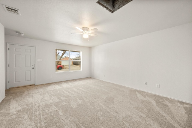 carpeted spare room with ceiling fan