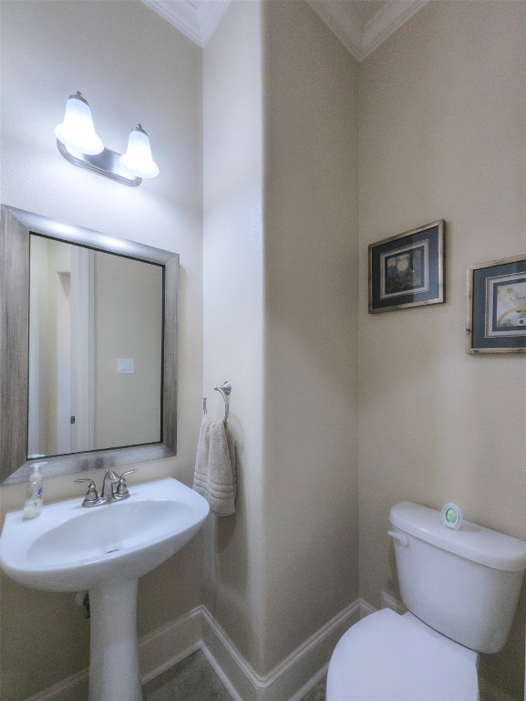 bathroom featuring toilet and ornamental molding