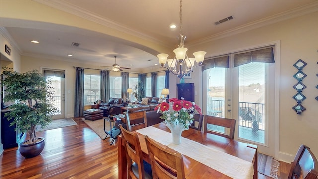 dining room featuring ceiling fan with notable chandelier, dark hardwood / wood-style floors, and a wealth of natural light