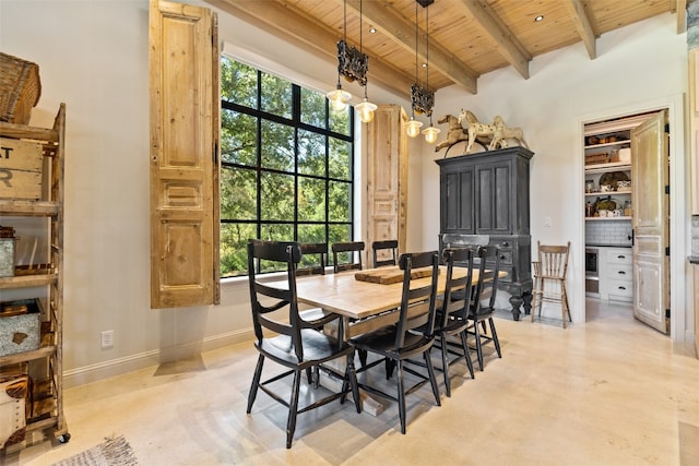 dining room featuring beamed ceiling and wood ceiling