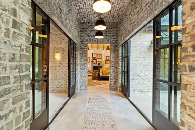 wine cellar with french doors, a healthy amount of sunlight, and brick ceiling