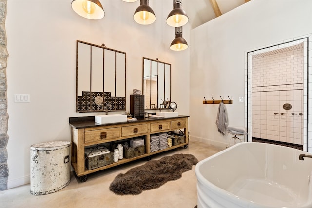 bathroom featuring double sink vanity and a washtub